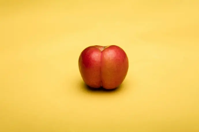 2 red apples on white table